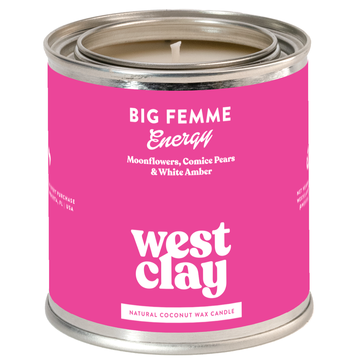 A West Clay candle in a cylindrical metal tin with a bright pink label. The label reads 'BIG FEMME Energy' and 'west clay' in white text, with 'NATURAL COCONUT WAX CANDLE' at the bottom.